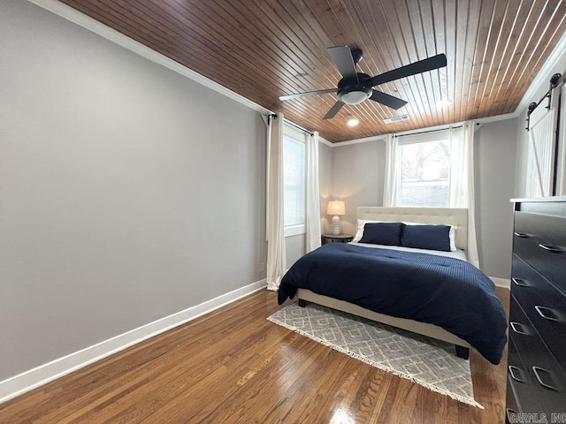 1701 N University, Little Rock, AR 72207 - bedroom with a barn door, crown molding, wooden ceiling, baseboards, and wood finished floors