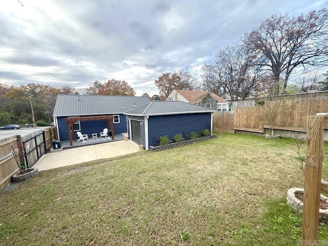 1701 N University, Little Rock, AR 72207 - rear view of house featuring metal roof, a patio area, and a garage