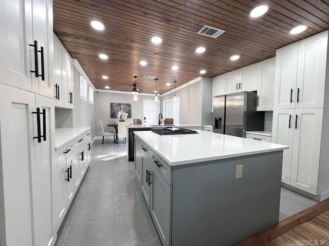1701 N University, Little Rock, AR 72207 - kitchen with stainless steel fridge with ice dispenser, a ceiling fan, a spacious island, wood ceiling, and light countertops