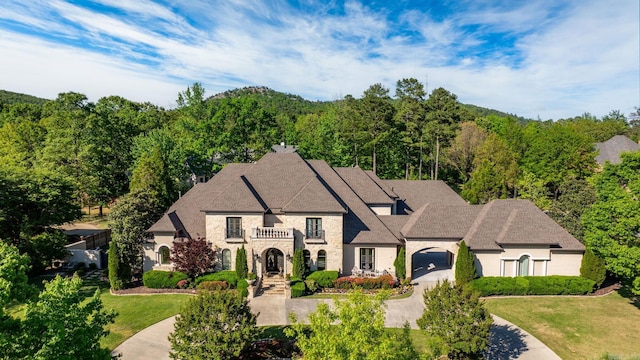 64 Sologne Cir, Little Rock, AR 72223 - french country style house with stone siding, a view of trees, and a front lawn