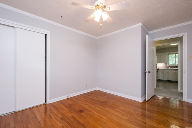 25 Barbara Cir, Little Rock, AR 72204 - unfurnished bedroom with wood finished floors, baseboards, ornamental molding, a closet, and ceiling fan