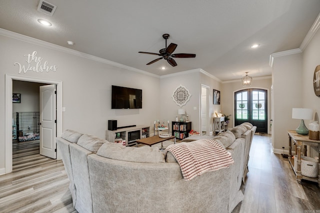1715 Sylar Cir, Conway, AR 72034 - living room featuring light wood-style floors, ornamental molding, ceiling fan, baseboards, and recessed lighting