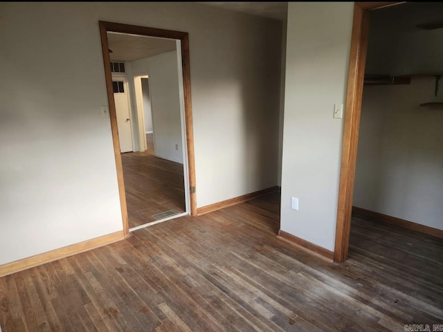 104 W Searcy, Searcy, AR 72082 - unfurnished bedroom with wood finished floors, baseboards, a closet, and a spacious closet