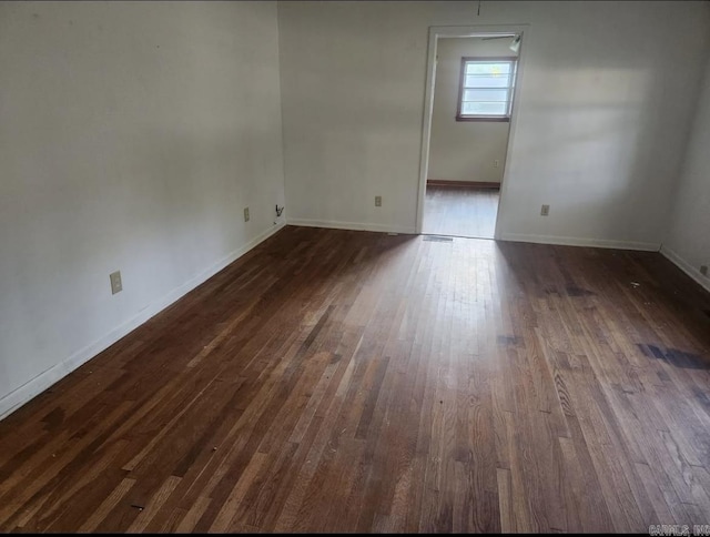 104 W Searcy, Searcy, AR 72082 - empty room with dark wood-style flooring and baseboards