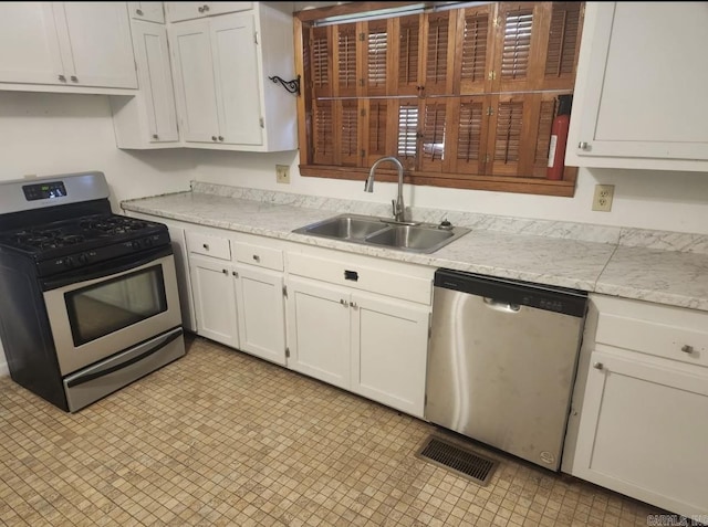 104 W Searcy, Searcy, AR 72082 - kitchen featuring stainless steel appliances, a sink, light countertops, and white cabinets