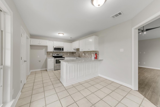 14 Woodbridge, Cabot, AR 72023 - kitchen featuring stainless steel appliances, a peninsula, a ceiling fan, white cabinetry, and a sink