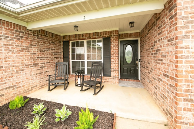 14 Woodbridge, Cabot, AR 72023 - view of exterior entry featuring brick siding and covered porch