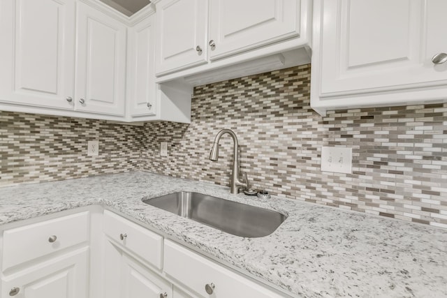 14 Woodbridge, Cabot, AR 72023 - kitchen featuring a sink, tasteful backsplash, white cabinets, and light stone countertops