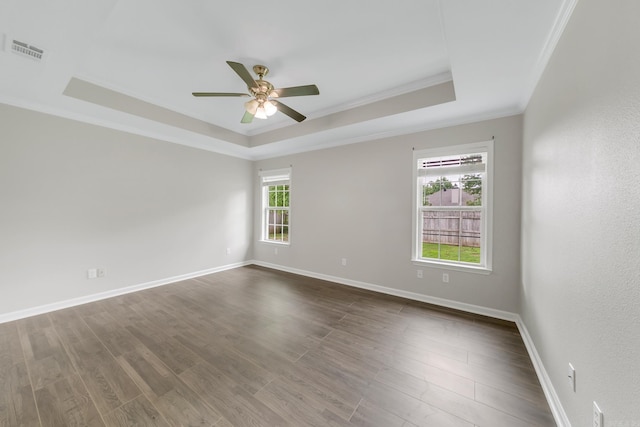 14 Woodbridge, Cabot, AR 72023 - spare room featuring a raised ceiling, crown molding, a ceiling fan, baseboards, and dark wood-style flooring