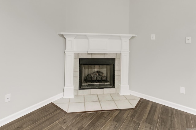 14 Woodbridge, Cabot, AR 72023 - detailed view of wood finished floors, baseboards, and a tiled fireplace