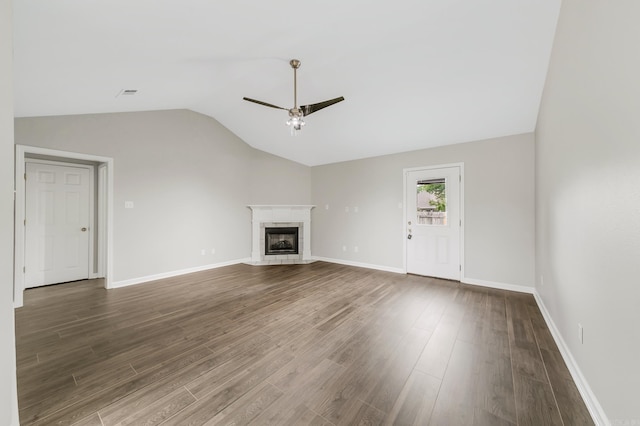 14 Woodbridge, Cabot, AR 72023 - unfurnished living room featuring ceiling fan, lofted ceiling, wood finished floors, a tile fireplace, and baseboards