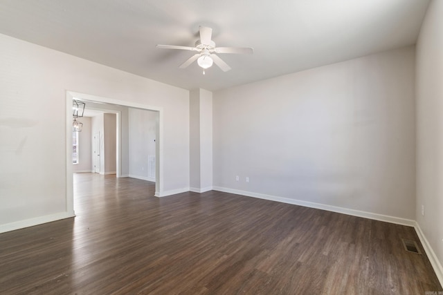 1403 Scott, Conway, AR 72032 - unfurnished room with dark wood finished floors, ceiling fan, and baseboards