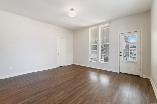 1403 Scott, Conway, AR 72032 - spare room with dark wood-style flooring and baseboards