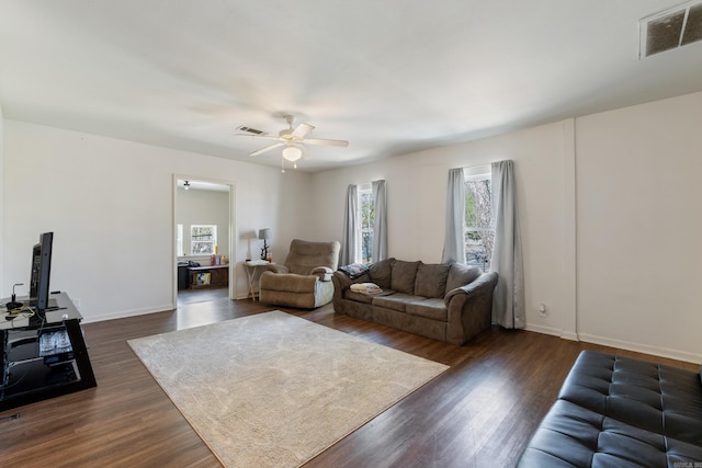 1403 Scott, Conway, AR 72032 - living room featuring a ceiling fan, dark wood finished floors, and baseboards