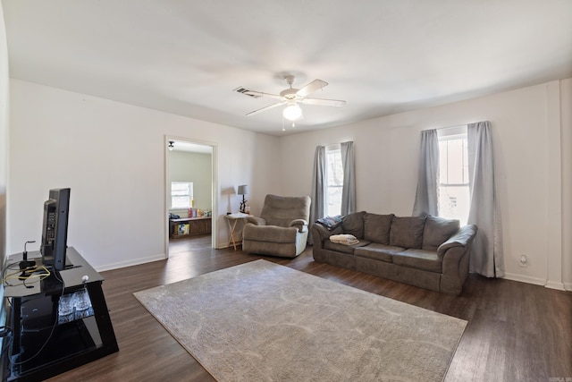 1403 Scott, Conway, AR 72032 - living area featuring a ceiling fan, dark wood-type flooring, and baseboards