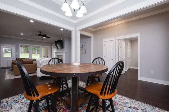11316 Barrett Rd, Roland, AR 72135 - dining space featuring a chandelier, wood finished floors, crown molding, baseboards, and a fireplace