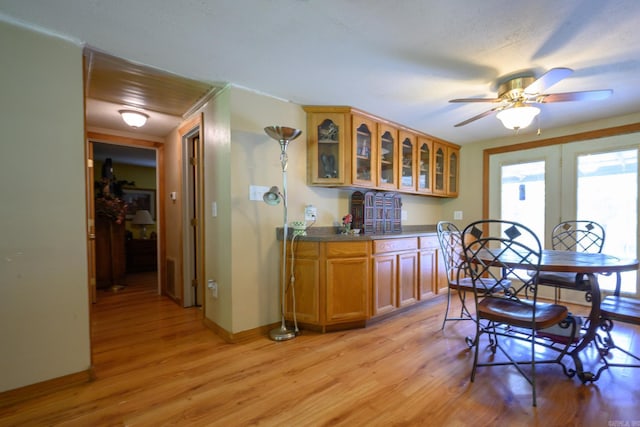 1702 Carolina Dr, Mena, AR 71953 - dining area with light wood-type flooring, wet bar, baseboards, and a ceiling fan