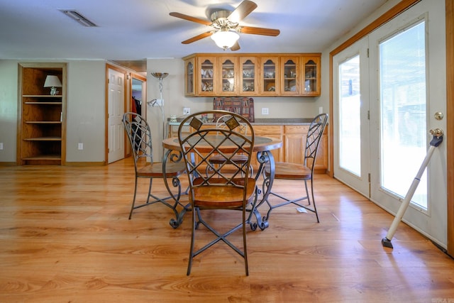 1702 Carolina Dr, Mena, AR 71953 - dining room with light wood-type flooring, built in features, baseboards, and a ceiling fan