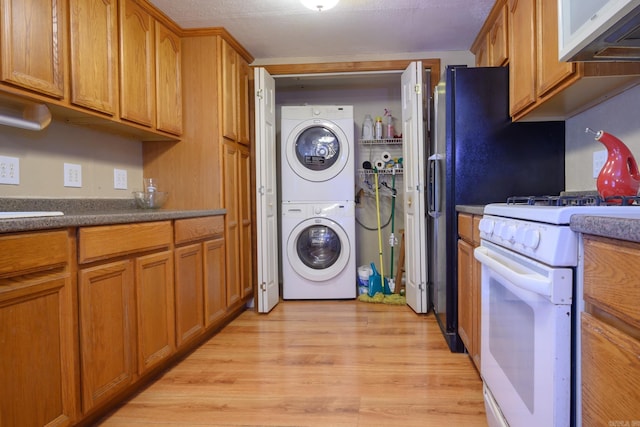 1702 Carolina Dr, Mena, AR 71953 - laundry room with stacked washer / drying machine and light wood-type flooring
