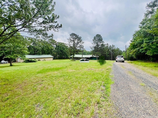 1702 Carolina Dr, Mena, AR 71953 - view of grassy yard with gravel driveway