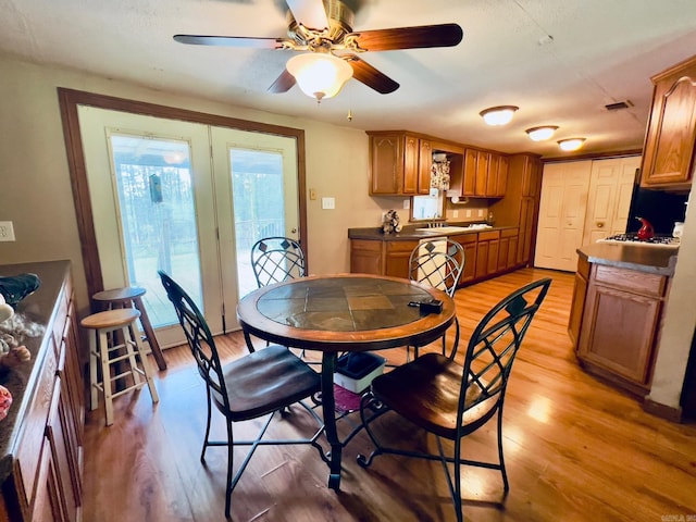 1702 Carolina Dr, Mena, AR 71953 - dining space with light wood-style flooring and a ceiling fan