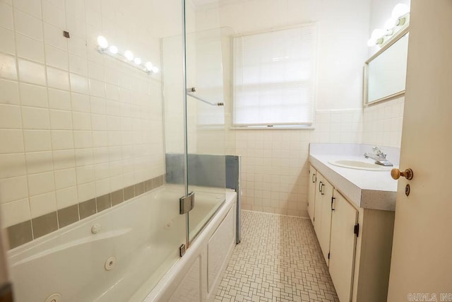 327 N Holloway Ave, El Dorado, AR 71730 - full bathroom featuring tile walls, vanity, a combined bath / shower with jetted tub, and tile patterned flooring