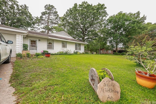 327 N Holloway Ave, El Dorado, AR 71730 - view of green lawn featuring an attached garage