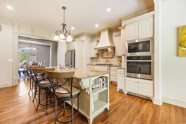 4 Bellegarde Dr, Little Rock, AR 72223 - kitchen with stainless steel appliances, a chandelier, premium range hood, open shelves, and backsplash