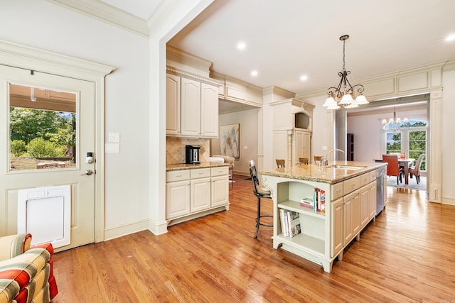4 Bellegarde Dr, Little Rock, AR 72223 - kitchen with open shelves, a chandelier, light wood-style floors, ornamental molding, and decorative backsplash