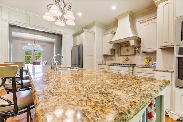 4 Bellegarde Dr, Little Rock, AR 72223 - kitchen with a chandelier, a sink, appliances with stainless steel finishes, ornamental molding, and a kitchen island with sink