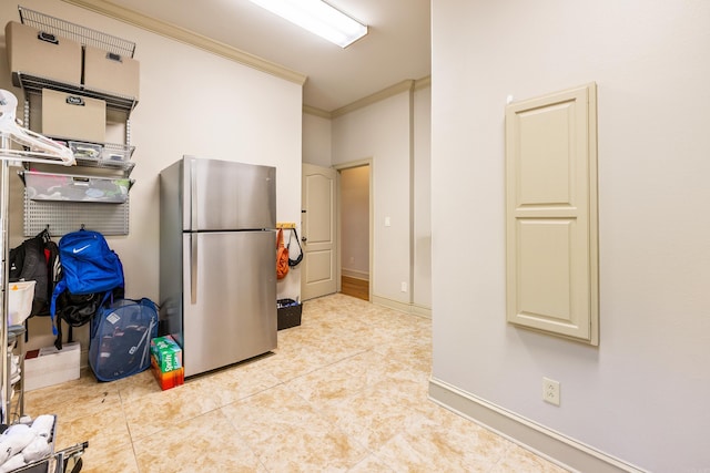 4 Bellegarde Dr, Little Rock, AR 72223 - kitchen featuring freestanding refrigerator, ornamental molding, light tile patterned floors, cream cabinets, and baseboards