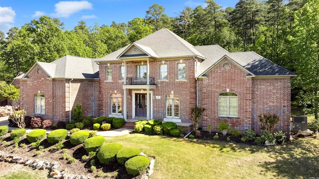 4 Bellegarde Dr, Little Rock, AR 72223 - georgian-style home with a front yard, brick siding, roof with shingles, and cooling unit