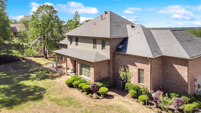 4 Bellegarde Dr, Little Rock, AR 72223 - rear view of property with brick siding, a lawn, a shingled roof, cooling unit, and a patio area