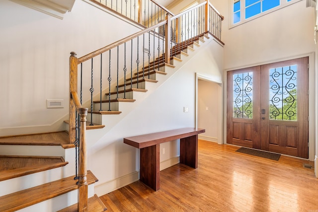 4 Bellegarde Dr, Little Rock, AR 72223 - entrance foyer featuring wood finished floors, stairs, baseboards, a towering ceiling, and french doors