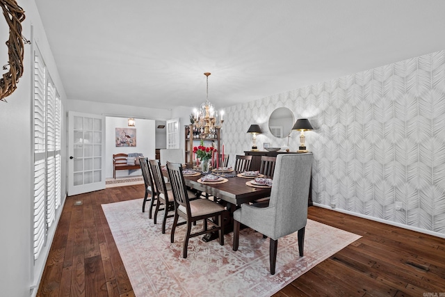 50 Heritage Park Cir, North Little Rock, AR 72116 - dining room featuring wallpapered walls, an accent wall, baseboards, wood-type flooring, and a chandelier