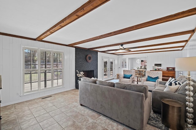 50 Heritage Park Cir, North Little Rock, AR 72116 - living area with light tile patterned flooring, beamed ceiling, a ceiling fan, a brick fireplace, and baseboards