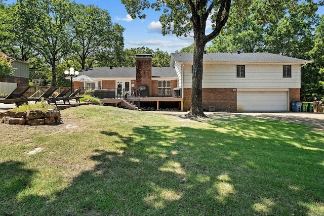 50 Heritage Park Cir, North Little Rock, AR 72116 - back of house featuring brick siding, an attached garage, a wooden deck, driveway, and a yard