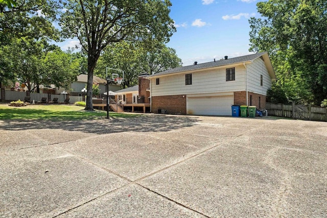 50 Heritage Park Cir, North Little Rock, AR 72116 - back of property featuring brick siding, an attached garage, and driveway