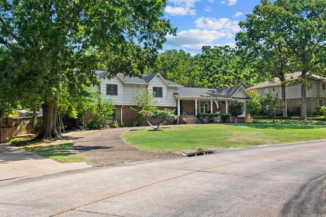 50 Heritage Park Cir, North Little Rock, AR 72116 - split level home with brick siding, driveway, covered porch, and a front lawn
