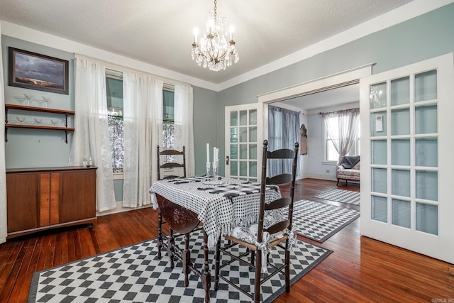 321 Hazel St, Hot Springs, AR 71901 - dining area featuring wood finished floors, a chandelier, a textured ceiling, and french doors