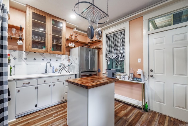 321 Hazel St, Hot Springs, AR 71901 - kitchen featuring butcher block countertops, freestanding refrigerator, a sink, wood finished floors, and backsplash