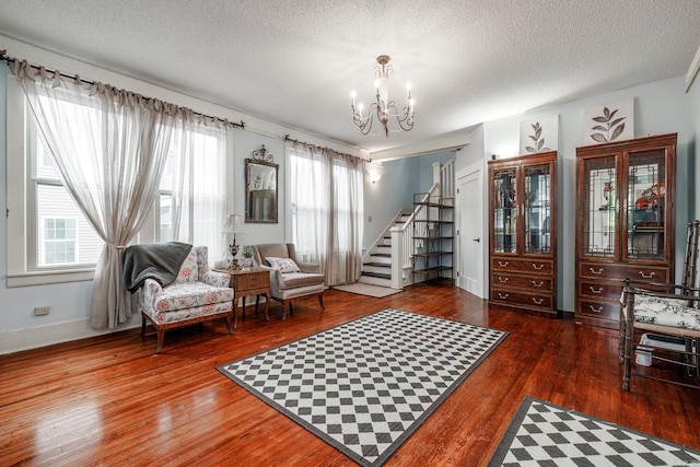321 Hazel St, Hot Springs, AR 71901 - living area featuring stairs, a chandelier, wood finished floors, a textured ceiling, and baseboards