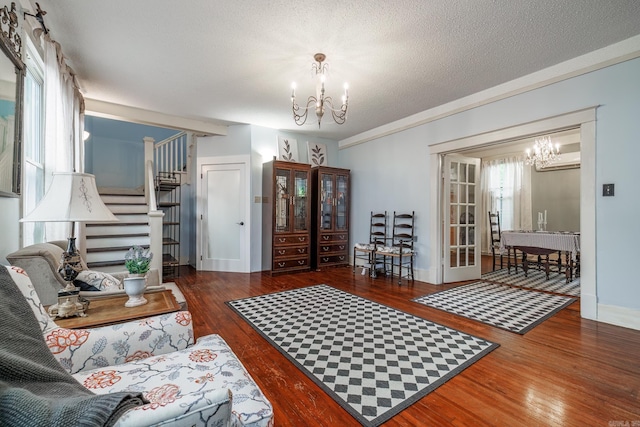 321 Hazel St, Hot Springs, AR 71901 - living room with a chandelier, wood finished floors, stairs, and a textured ceiling