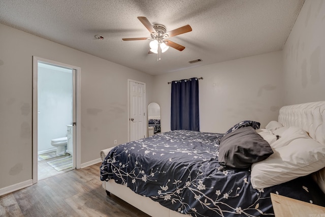 306 Ray St, Cabot, AR 72023 - bedroom featuring wood finished floors, a textured ceiling, ensuite bathroom, a ceiling fan, and baseboards