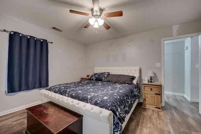306 Ray St, Cabot, AR 72023 - bedroom featuring wood finished floors, a textured ceiling, baseboards, and ceiling fan