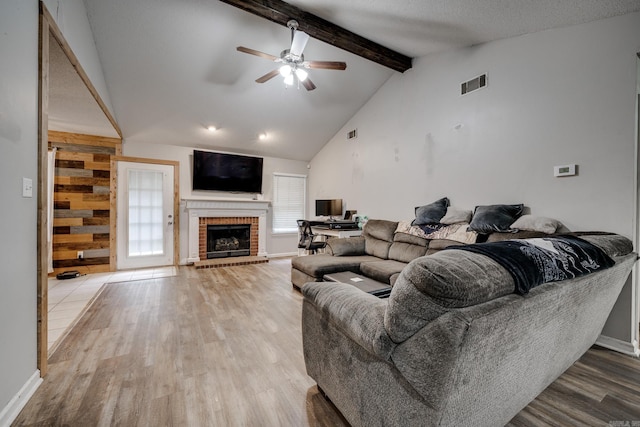 306 Ray St, Cabot, AR 72023 - living area with wood finished floors, ceiling fan, a brick fireplace, and baseboards