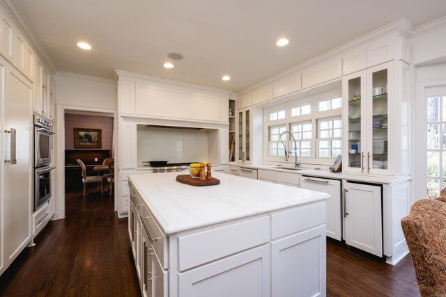 148 Pleasant Valley Dr, Little Rock, AR 72212 - kitchen with a sink, stainless steel double oven, dark wood finished floors, dishwasher, and white cabinetry