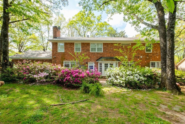 148 Pleasant Valley Dr, Little Rock, AR 72212 - rear view of property featuring a chimney, brick siding, and a yard