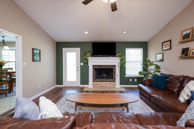 2418 Hickorynut Ct, Little Rock, AR 72211 - living area with lofted ceiling, plenty of natural light, a fireplace, ceiling fan, and wood finished floors