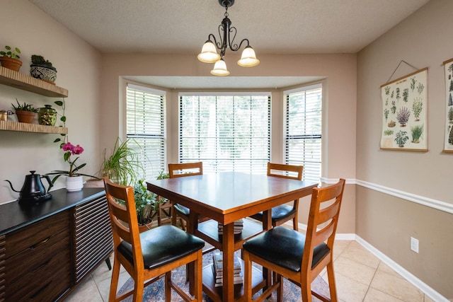2418 Hickorynut Ct, Little Rock, AR 72211 - dining area with healthy amount of natural light, light tile patterned floors, a chandelier, and a textured ceiling